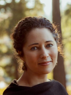 Kirstin Valdez Quade in front of a wooded background.