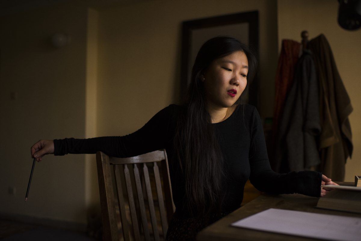 May Jeong sitting at a table.