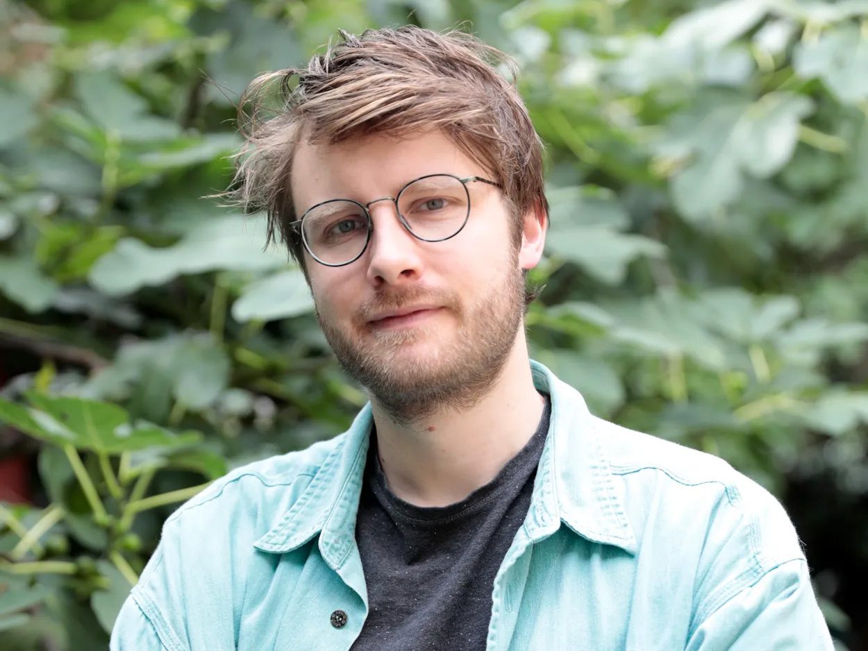 Wouter Haverals standing in front of a leafy background.