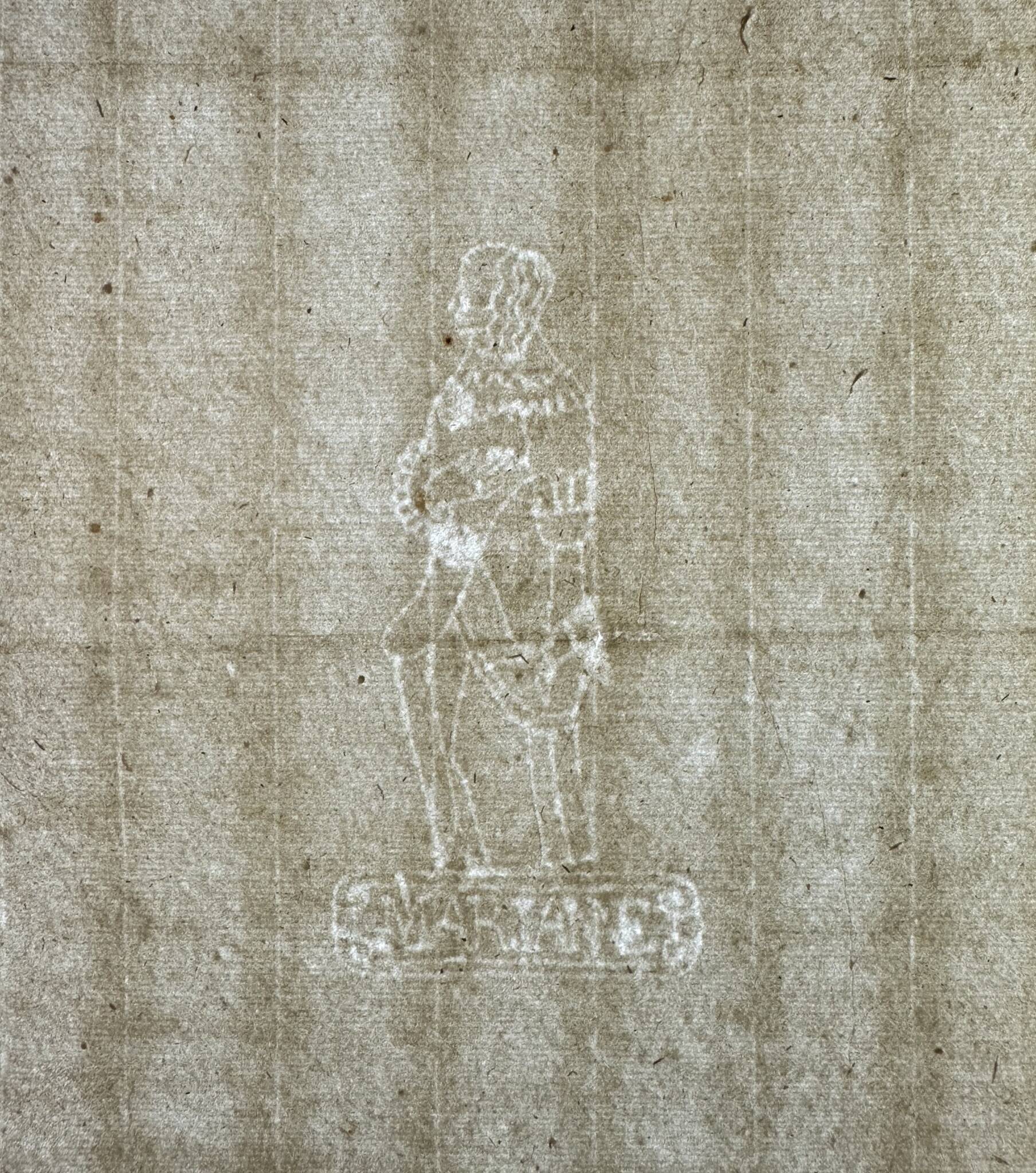 close-up of a sheet of paper showing a watermark in the shape of a human figure standing on a rectangular frame containing the word MARIANE.”