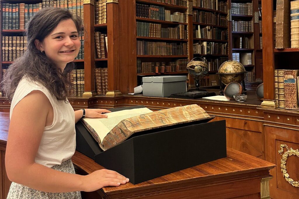 Student standing in library.
